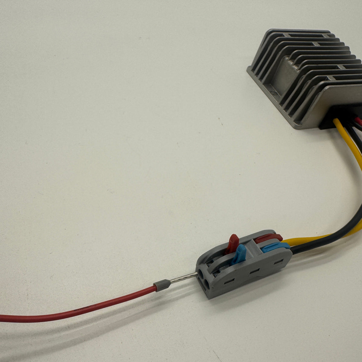 12V to 15V DC-DC converter showing a red wire entering the open lever connector