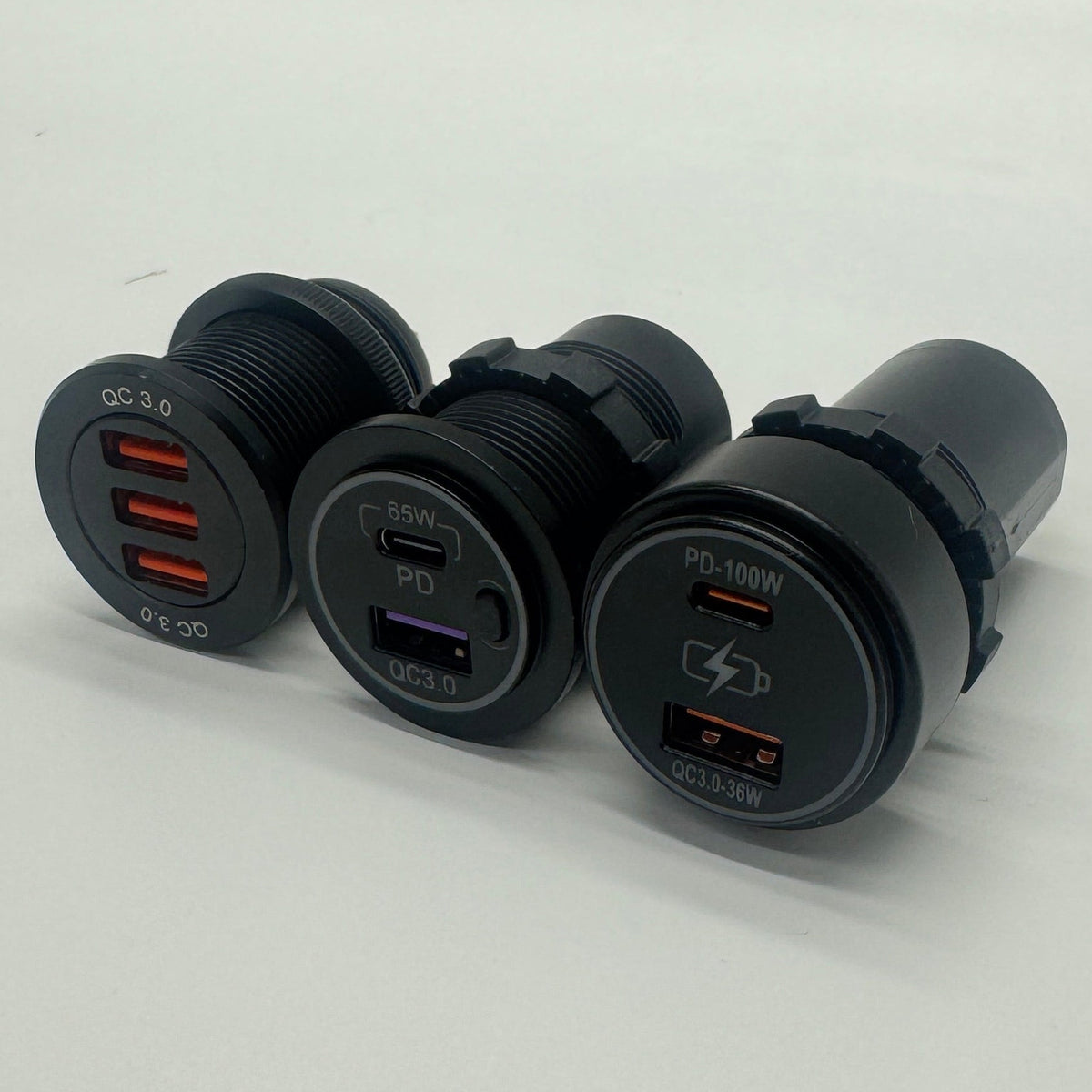 Angled view of 12V USB chargers showing triple USB-A, 65W USB-C PD and 100W USB-C PD options