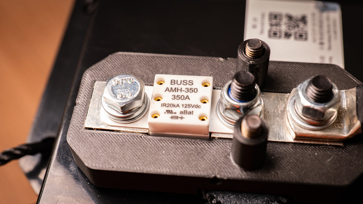 Close-up of a Bussmann AMH-350 350A lithium battery fuse mounted in its holder