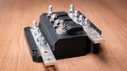 Side close-up of the Falcon 4-way 12V power distribution block showing fuse terminals and busbars