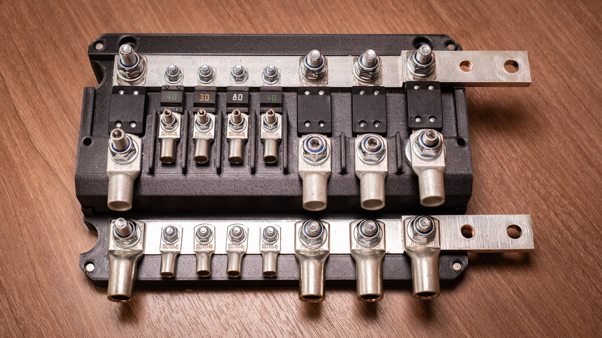 Top view of the uncovered Falcon 8-Way 12V Power Distribution Block showing MEGA and MIDI fuse positions and terminal lugs