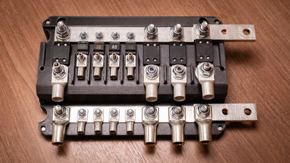 Top view of the uncovered Falcon 8-Way 12V Power Distribution Block showing MEGA and MIDI fuse positions and terminal lugs