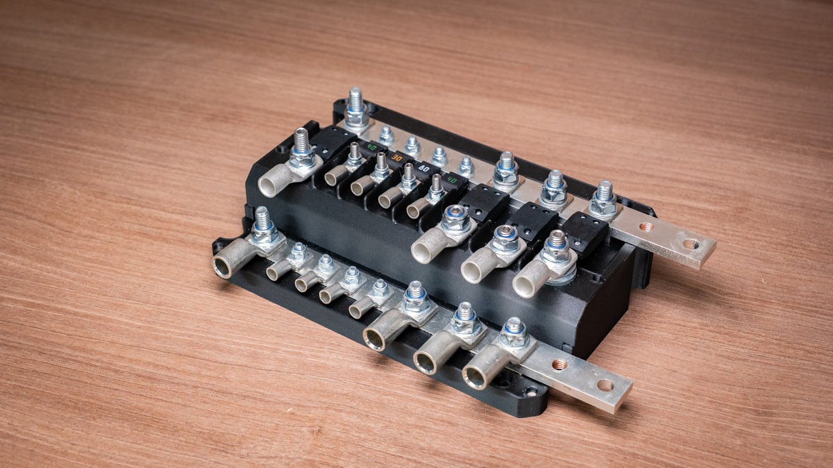 Falcon 8-Way 12V Power Distribution Block with cover removed, showing fuses, terminal lugs and joining busbars