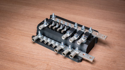 Falcon 8-Way 12V Power Distribution Block with cover removed, showing fuses, terminal lugs and joining busbars