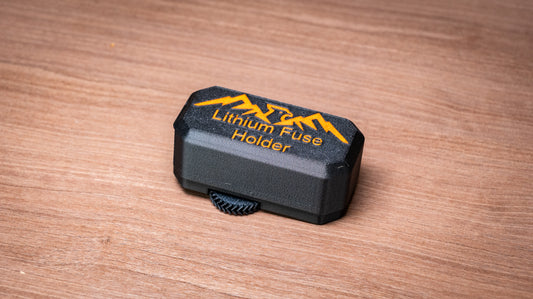 Falcon lithium battery fuse holder with black protective cover and orange lettering