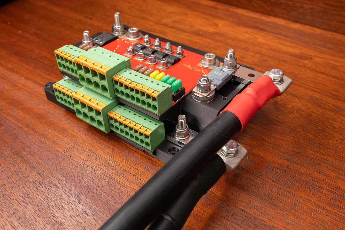 Falcon switching and distribution hub with cover removed and heavy battery cables connected to the side busbars
