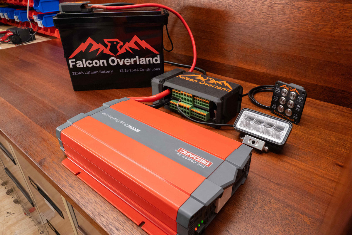 Falcon switching and distribution hub connected to a lithium battery and inverter, with a control panel and work light