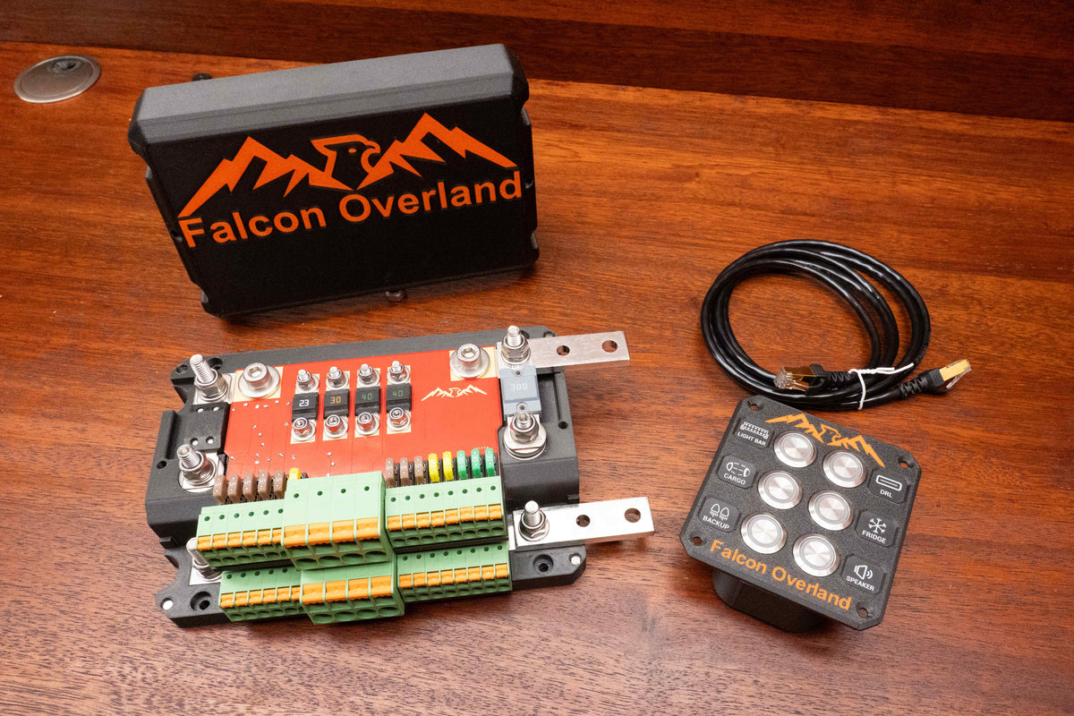 Falcon switching and distribution hub with cover removed, showing fuses and terminals beside the control panel and cable