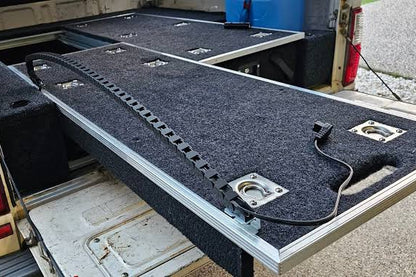 Cable chain running along an extended carpeted fridge slide drawer with a power lead