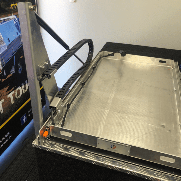 Cable chain installed beside an empty metal fridge slide tray