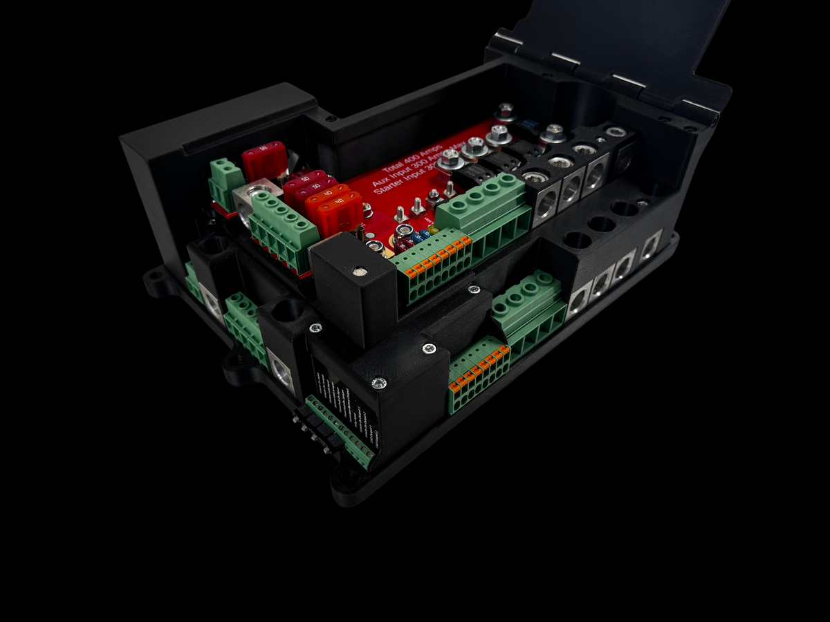 Giga Power Hub 12V power distribution system with open cover revealing red circuit board, blade fuses and green connectors