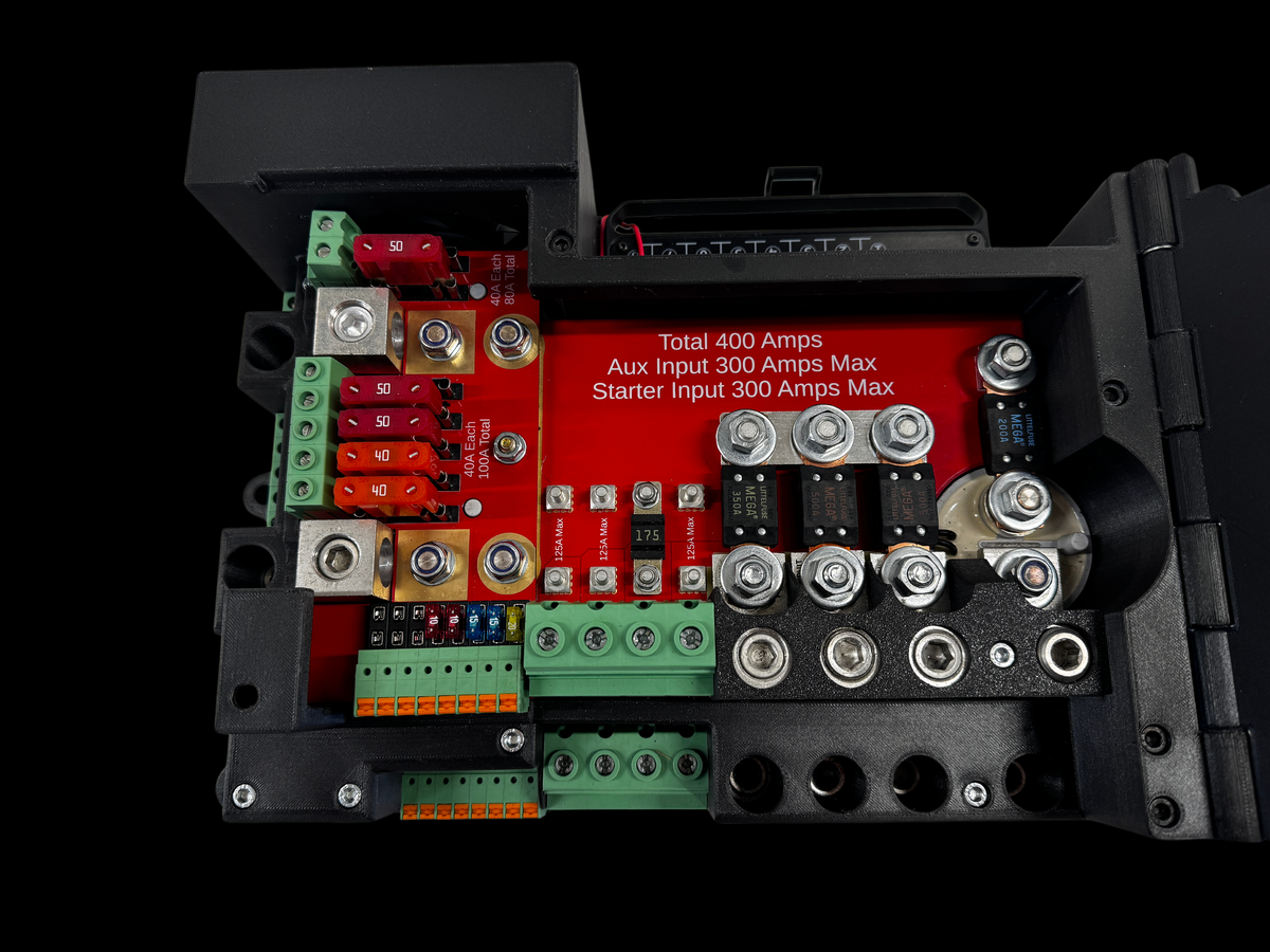 Top view inside the Giga Power Hub 12V power distribution system, showing fuses, bolted terminals and red circuit board