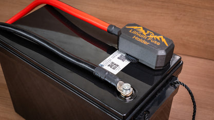 Covered lithium battery fuse holder connected to red and black battery cables