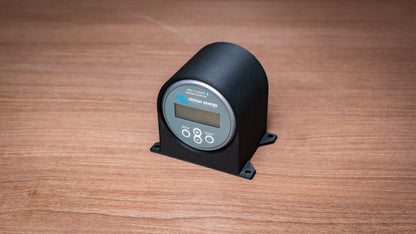 Angled view of the Victron battery monitor holder showing its curved enclosure and mounting feet